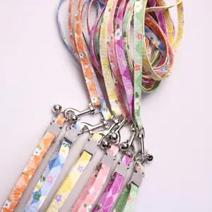Floral pet leash and collar set with metal clasp and bell for small and medium cats and dogs.