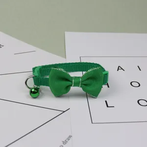 Green pet collar with cute bow and bell, durable fabric neck strap for cats and small dogs.