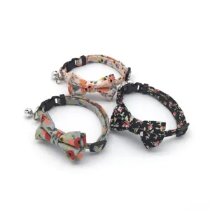 Close-up detail of floral cat collar with cute bow and bell, soft fabric and safe buckle.
