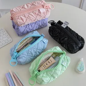 Stylish quilted cosmetic bag with oversized zipper, large capacity portable travel makeup pouch.