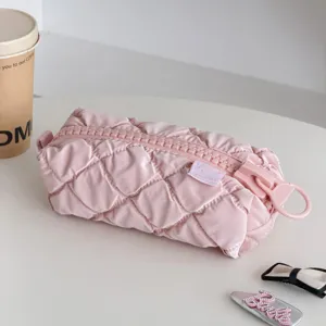 Pink quilted cosmetic bag detail, cute large zipper design, soft fabric makeup pouch.