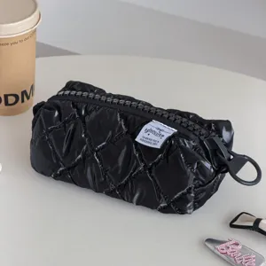 Black shiny quilted cosmetic bag large capacity travel portable toiletry storage pouch.