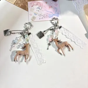 Cute flocked deer keychain with delicate lace ribbon and sweet pink white charm for bag decoration.