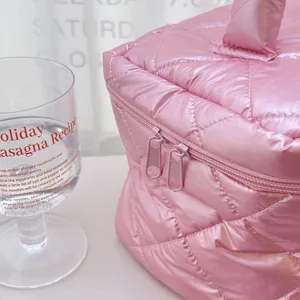 Pink quilted cosmetic bag, pearlescent travel makeup pouch, stylish portable wash organizer.