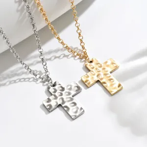 French vintage hammered cross pendant necklace set, gold and silver metal fashion jewelry detail.