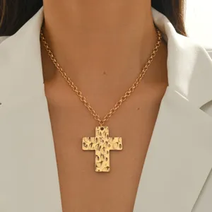 French retro hammered cross necklace pendant shot, elegant golden metal chain fashion jewelry.