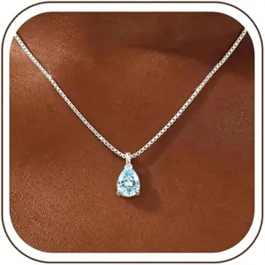 Close-up of a stunning pear-shaped light blue zircon pendant necklace on a delicate silver box chain.