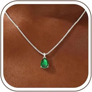 Close-up view of a pear-shaped green zircon pendant on a silver box chain necklace.