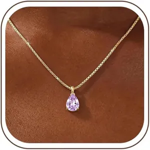 Close-up detail of a stunning gold-plated pear-cut purple cubic zirconia pendant necklace.