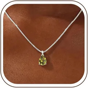 Close-up detail of teardrop green zircon pendant necklace with delicate silver box chain.