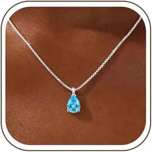 Close-up of pear-shaped blue zircon pendant necklace worn on neck, elegant detailed jewelry shot.