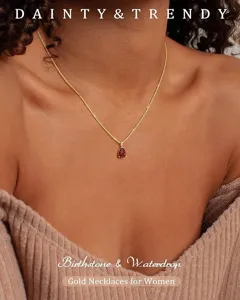 Close-up detail of the elegant teardrop birthstone necklace pendant, polished gold finish.