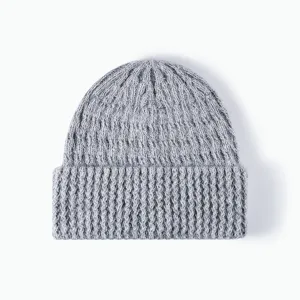 Grey ribbed knitted beanie hat detail, cozy winter warm wool blend cuffed cap texture view.