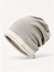 Closeup view of the winter colorblock knit beanie, cozy slouchy warm cap in gray and beige.
