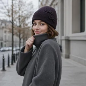 Chic dark purple knit beanie for women featuring cute bow details, warm and stylish winter hat.