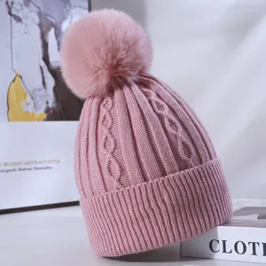 Pink knit beanie hat with large fluffy pom pom, thick warm winter slouchy cap for women.