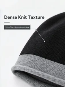 Close-up detail of black grey colorblock knit beanie hat, thick warm winter cold hat texture