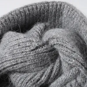 Close up detail of soft grey rabbit hair blend knit beanie showing cozy winter texture.
