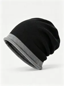 Close-up detail of the black and grey colorblock knit beanie, soft warm wool texture.