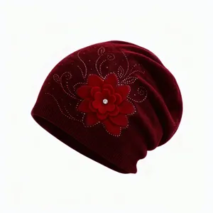 Burgundy knit slouchy beanie with 3D felt flower and rhinestone details, winter warmth.