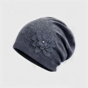Grey knit slouchy beanie detail, 3d flower rhinestone decor, warm winter hat closeup.