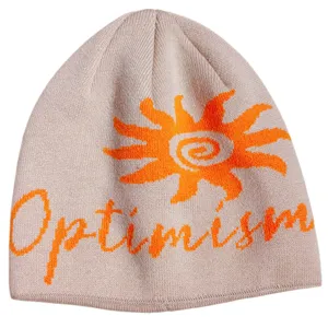 Close-up detail of a retro sun knitted beanie with optimism text for winter warmth.