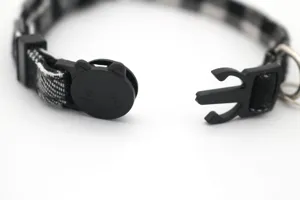 Black and white plaid cat collar with cute safety buckle for kitten and puppy pets detail.