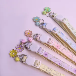 Floral cat and dog collar detail view with cute bell and flower pendant, soft pet neck accessory.