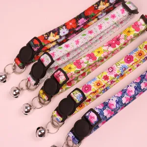 Detailed close-up view of floral cat collars featuring safety buckles and bells.