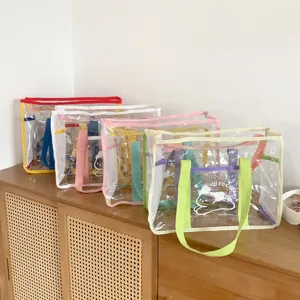 Clear PVC tote bag with colorful handles, perfect detail view for beach and outdoor use.