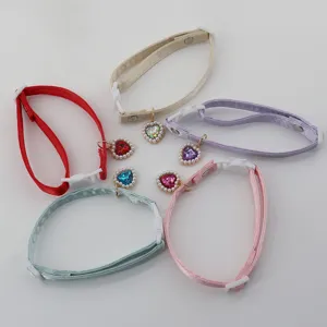 Cute satin pet collar with crystal heart pendant, detailed cat and dog neck accessories.