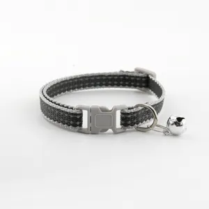 Detailed view of the black and grey woven pet collar featuring a durable plastic buckle.
