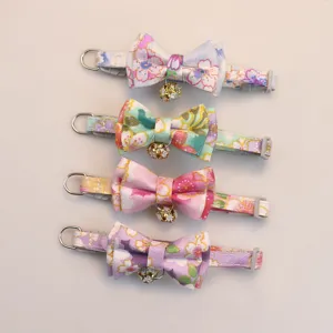 Floral pet collar with bow and bell, soft fabric cat dog neck accessory, detail view.