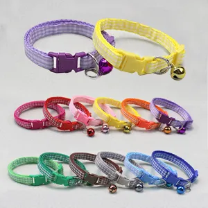 Detailed view of colorful plaid pet collars featuring quick-release buckles and cute small bells.