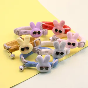 Detailed view of cute plush rabbit pet collars with colorful straps, sunglasses and bells.