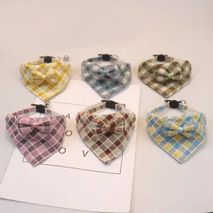 Cute plaid pet bandana collar with bow and bell, soft cotton blend for cats and dogs.