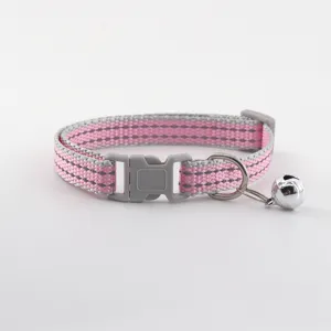 Detailed view of pink and grey reflective cat collar with safety buckle and cute bell.