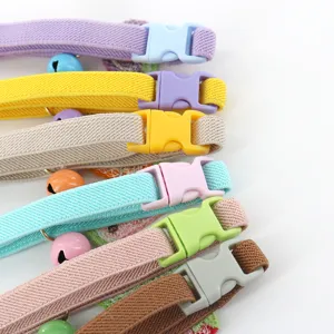 Gedetailleerd overzicht van kleurrijke elastische huisdierhalsbandjes met belletjes en gespen.