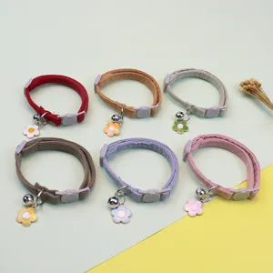 Detailed view of cute corduroy pet collar with bell and flower pendant, adjustable size for cats.
