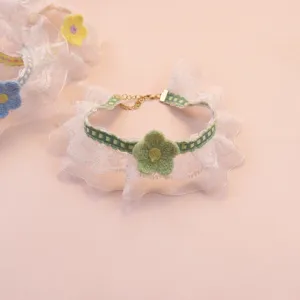 Cute lace pet collar detail showcasing green knitted floral decoration and adjustable gold chain.