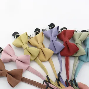 Close-up detail of colorful pet bow tie collars with cute bells and adjustable buckles.