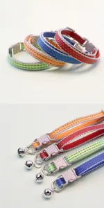 Reflective pet collar detail showing nylon webbing, plastic buckle and metal bell features.