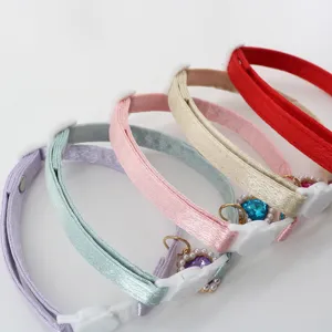 Detailed close-up of a stylish satin pet collar featuring a cute heart crystal charm.