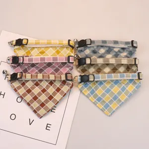 Cute plaid pet bandana collar with safety buckle and bell, soft cotton fabric for cats and dogs.