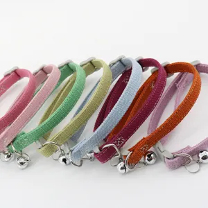 Colorful fabric pet collar with bell, adjustable safety strap for cats and small dogs detail.