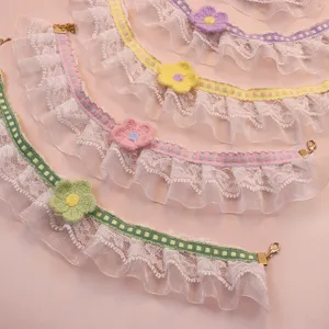 Detailed shot of cute lace pet collar with handmade knit flower, delicate ruffle design.