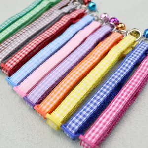 Colorful plaid pet collar detail featuring cute bell and secure buckle for dogs cats.