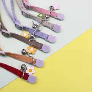 Corduroy pet collar with bell and flower pendant, adjustable safety buckle for cats and dogs.