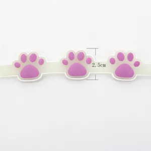 Glow in the dark pet collar strap with cute purple paw prints, made of flexible silicone material.