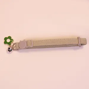 Cute pet corduroy collar detail with bell and flower charm for cats and dogs, adjustable design.